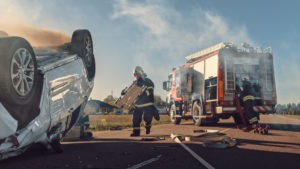 First responders handle an overturned car