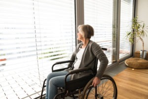 woman-in-a-wheelchair-looking-out-her-back-door